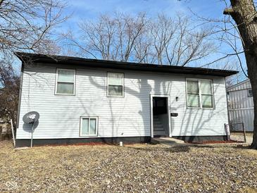 Ranch home with gray siding, black accents, and a landscaped yard at 9508 Conried Dr, Indianapolis, IN 46235