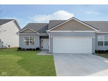 Gray siding ranch home with attached garage and landscaping at 1623 Capra Ct, Beech Grove, IN 46107