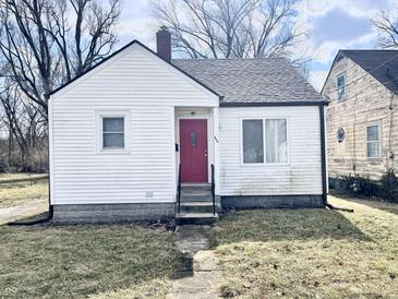 Charming single-story home featuring a red front door and a classic white exterior at 711 W 24Th St, Anderson, IN 46016
