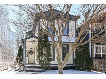 Charming two-story home showcasing a welcoming front porch and classic architectural details at 747 E Mccarty St, Indianapolis, IN 46203