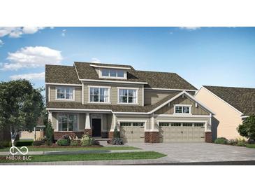 Charming two-story home featuring a three-car garage, well-maintained lawn, and attractive architectural details at 15377 Manderley St, Fishers, IN 46040
