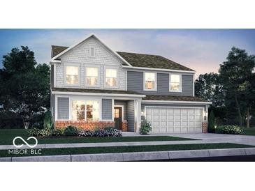 Beautiful two-story home featuring gray siding, brick accents, and a two-car garage at 16923 Sandhurst Pl, Westfield, IN 46074