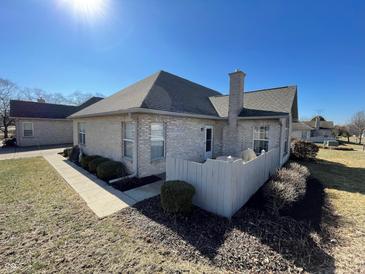 Back exterior view of home featuring brick, chimney, fence and landscaped yard at 5850 Bradston Way, Indianapolis, IN 46237