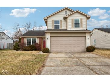 Two-story house with beige siding, red brick, and a two-car garage at 6354 River Run Dr, Indianapolis, IN 46221