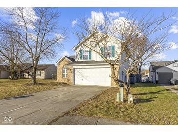 Two-story house with attached garage and manicured lawn at 7307 Thornmill Ct, Avon, IN 46123