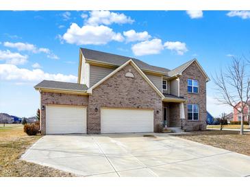 Charming two-story brick home featuring a three-car garage and manicured landscaping at 16457 Anderson Way, Noblesville, IN 46062