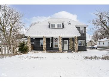 Charming home exterior featuring stone pillar accents on a snow-covered lot at 602 N Harrison St, Alexandria, IN 46001