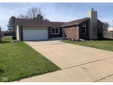Charming single-story home with a brick facade, attached garage, and a well-manicured lawn at 971 Alexander St, Greenwood, IN 46143