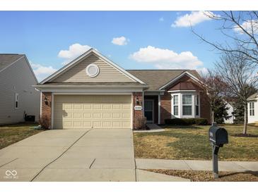 Charming single-story brick home with a two-car garage and well-maintained lawn at 13998 Avalon Blvd, Fishers, IN 46037