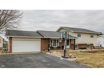 Two-story home features brick and siding exterior, attached garage, and a basketball hoop in the driveway at 362 1400 N, Summitville, IN 46070