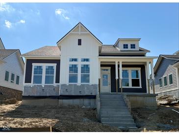 Two-story home featuring white and dark siding, large windows, and a front porch with steps at 20017 Old Dock Rd, Westfield, IN 46074