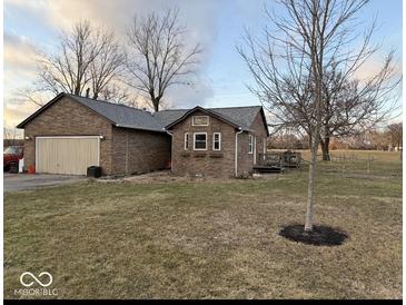 Charming brick home featuring a detached garage and a well-maintained lawn at 2650 W State Road 252, Flat Rock, IN 47234