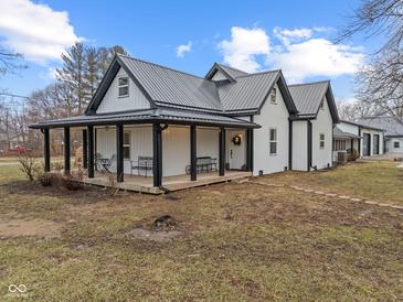 Charming exterior elevation of home featuring a metal roof and a cozy covered porch with seating at 4131 N County Road 500 E, Danville, IN 46122