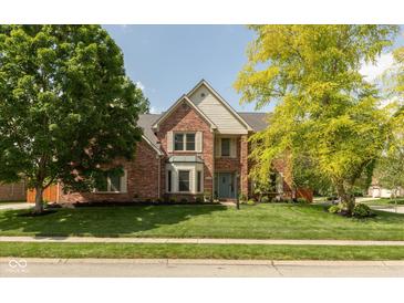 Charming two-story brick home with a well-manicured lawn and mature trees at 5208 Clear Lake Ct, Carmel, IN 46033