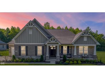 Charming single Gathering home with a brick facade, covered porch, and well-manicured lawn at 661 W 500 S, Greenfield, IN 46140