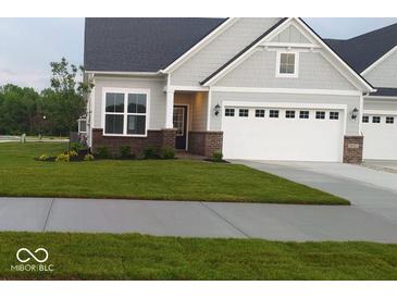 Charming single Gathering home with well-manicured lawn, brick accents, and attached two car garage at 9101 S Stone Trace S Blvd, Avon, IN 46123