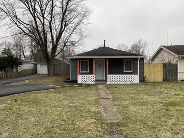 Charming home featuring a cozy front porch, fresh dark siding, and a well-maintained yard at 3314 S Parker Ave, Indianapolis, IN 46237