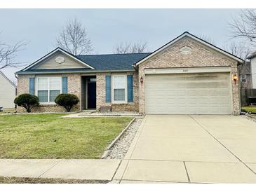Charming brick home with blue shutters, well-manicured lawn, and a two-car garage at 6405 Oyster Key Ln, Plainfield, IN 46168