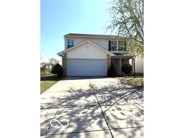 Two-story home featuring an attached two-car garage and well-maintained front yard at 7659 Misty Meadow Dr, Indianapolis, IN 46217