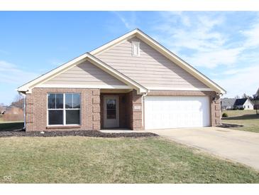 Charming single-story brick home featuring an attached two-car garage and manicured front lawn at 1393 N Salem Ct, Greenfield, IN 46140