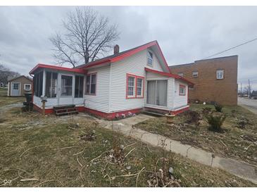 Charming house featuring a cozy front porch and a red trim, adding a touch of character to the property at 3624 Columbus Ave, Anderson, IN 46013