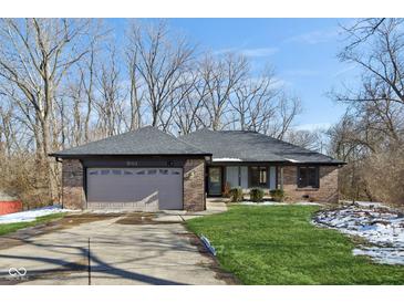 Charming single-story brick home featuring a two-car garage and well-maintained front lawn at 901 Detroit St, Beech Grove, IN 46107