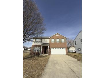 Charming two-story home with a brick and vinyl exterior, a two car garage, and a well-kept front lawn at 1881 Harvest Meadow Dr, Greenwood, IN 46143
