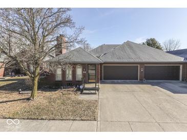 Charming brick home featuring a three-car garage and a well-manicured front yard and nice curb appeal at 223 Andrews Boulevard East Dr, Plainfield, IN 46168