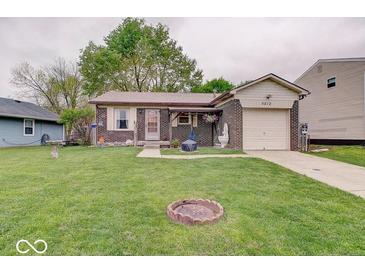 Charming brick home with a well-manicured lawn and a cozy, inviting front porch at 5212 Bahia Dr, Indianapolis, IN 46237