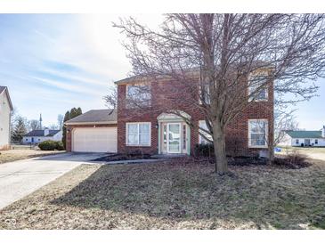 Two-story brick home with a well-maintained lawn and attached two-car garage at 6116 Bartley Ct, Indianapolis, IN 46236