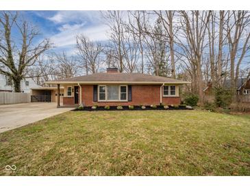 Charming one-story brick home featuring a well-manicured lawn and classic design elements at 208 Northshore Blvd, Anderson, IN 46011