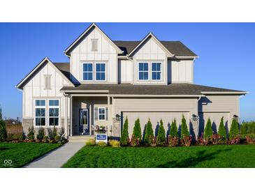 Charming two-story home featuring a welcoming front porch and a well-manicured lawn at 19840 Chatham Shore Ln, Westfield, IN 46074