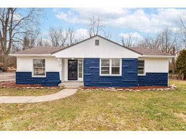 Charming one-story home with blue and white accents, landscaped yard and inviting front entrance at 3095 W 69Th St, Indianapolis, IN 46268