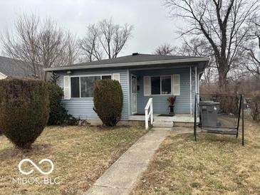 A single-story home featuring a gray exterior, complemented by well-maintained bushes and a cozy front porch at 3728 Orchard Ave, Indianapolis, IN 46218