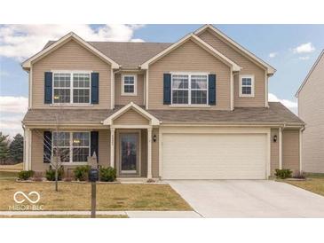 Charming two-story home with neutral siding, dark blue shutters, an attached two-car garage, and a well-manicured lawn at 5021 Greenside Dr, Indianapolis, IN 46235