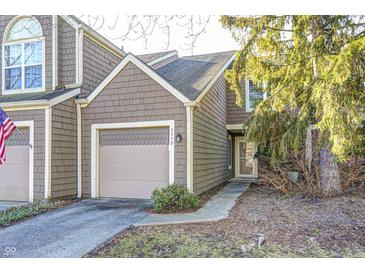 Charming two-story townhome with brown shingle siding and an attached one-car garage at 7459 Quincy Ct, Indianapolis, IN 46254
