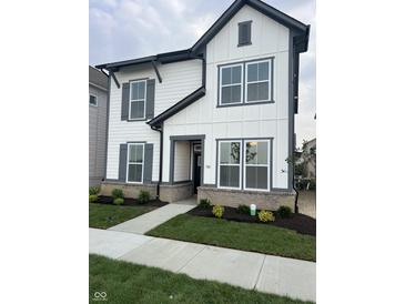 Charming two-story home with white siding, gray trim, and manicured front yard at 780 James William Ln, Westfield, IN 46074