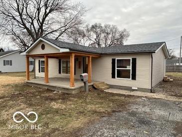 Inviting single-story home with a covered porch and neutral siding at 1007 N 10Th St, Elwood, IN 46036