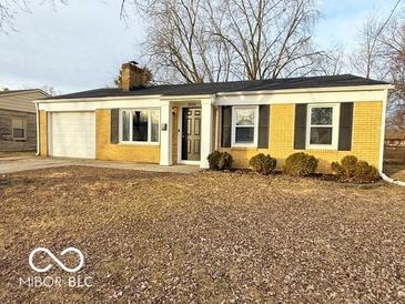 Charming single-story home with a yellow brick facade, attached garage, and well-maintained lawn at 3656 Allison Ave, Indianapolis, IN 46224