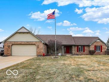 Charming single-story brick home with a well-maintained lawn and an American flag at 3926 Cranberry Dr, Greenfield, IN 46140