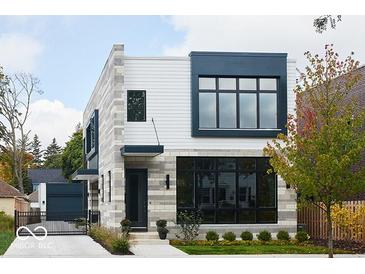 Modern two-story home with stone and siding, black-framed windows, and manicured landscaping at 2719 Carrollton Ave, Indianapolis, IN 46205