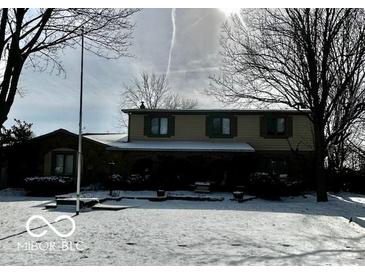 Charming two-story home featuring a well-maintained lawn covered in snow and classic architectural details at 296 Ironwood Ct, Carmel, IN 46033
