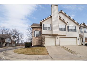 Charming townhome featuring a two-car garage, brick accents, and well-maintained landscaping at 475 Glenn Villa Ln # 144, Avon, IN 46123