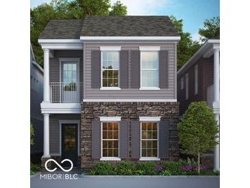 Charming two-story home with gray siding, stone accents, gray shutters, and a small front porch at 555 Gilder Dr, Carmel, IN 46032