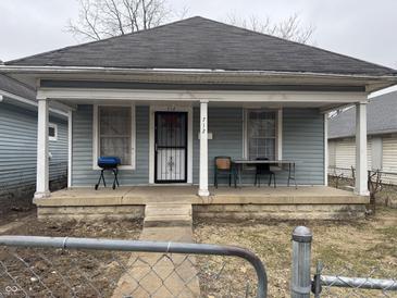Charming home featuring a cozy front porch for relaxing and entertaining outdoors at 712 Lynn St, Indianapolis, IN 46222
