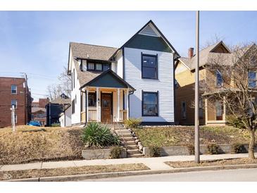 Charming renovated two-story home with inviting front porch and mature landscaping at 2110 N Talbott St, Indianapolis, IN 46202