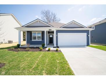 Charming single-Gathering home with a well-manicured lawn, two-car garage and covered porch at 5145 Cartland Dr, Indianapolis, IN 46239