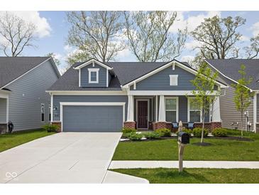 Charming single-story home features a well-manicured lawn, attached garage, and inviting front porch at 7188 Covington St, Lebanon, IN 46052
