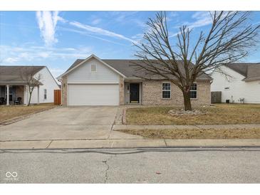 Charming single-story home featuring a two-car garage and a well-manicured front yard on a sunny day at 8091 Crumwell Dr, Avon, IN 46123