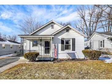 Charming bungalow-style home with white siding, black shutters, and a cozy front porch at 26 Highland Ave, Franklin, IN 46131